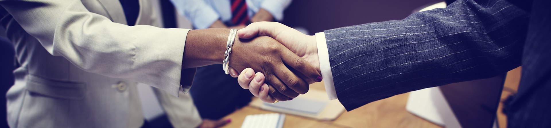 Business handshake across table | Attema Sales